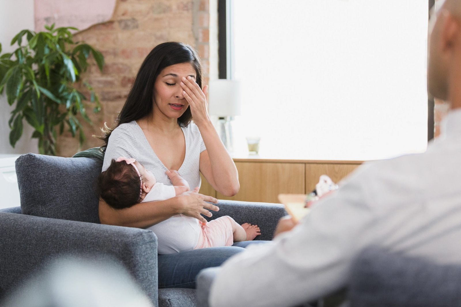 Emotionally distressed new mom shares with unrecognizable counselor